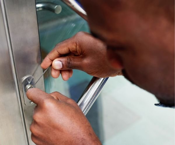 Locksmith opening a locked apartment door with professional tools