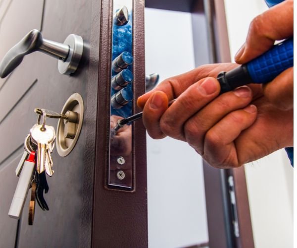 Locksmith repairing a jammed door lock mechanism